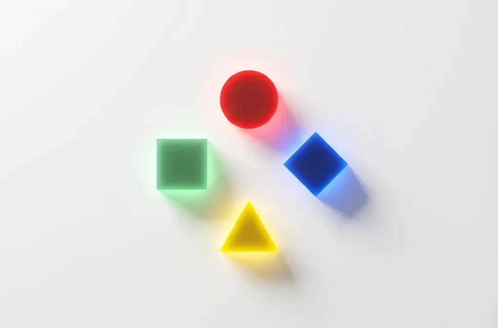 Vier geometrische vormen in DISC-kleuren: rode cirkel, gele driehoek, groene vierkant en blauwe diamant op witte achtergrond