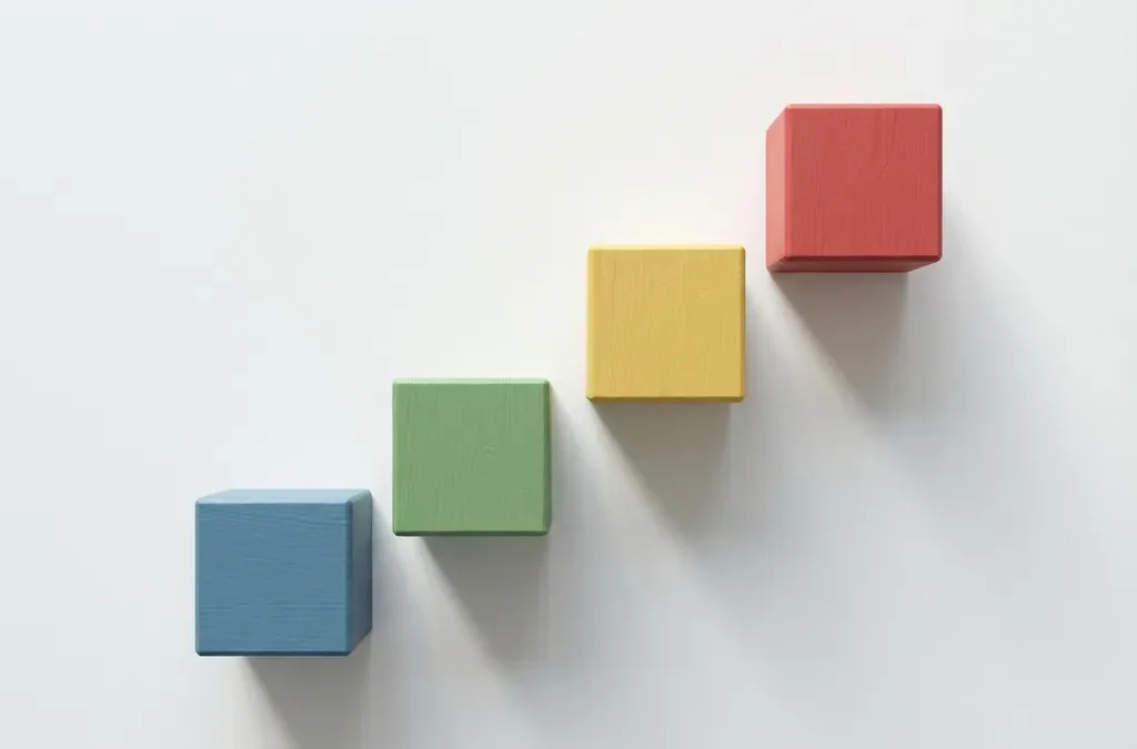 Vier gekleurde houten bouwblokken in rode, gele, groene en blauwe DISC-kleuren gerangschikt als oplopende trappen op witte ondergrond